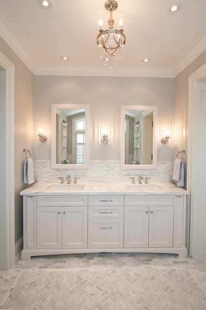 Large contemporary ensuite bathroom in Toronto with shaker cabinets, white cabinets, a freestanding bath, grey tiles, stone tiles, grey walls, marble flooring, a submerged sink, marble worktops and grey floors.