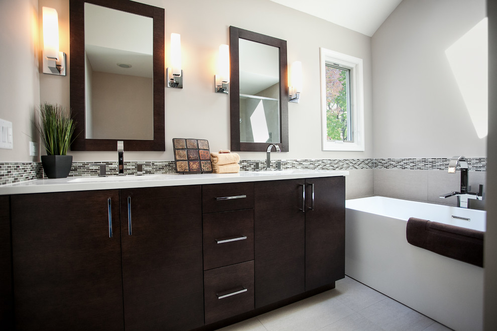 Aménagement d'une salle de bain principale contemporaine de taille moyenne avec un plan de toilette en quartz, une baignoire indépendante et un carrelage beige.