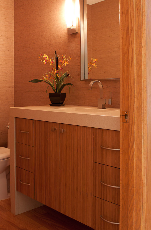 Exemple d'une salle de bain tendance avec un lavabo encastré, un placard à porte plane, des portes de placard marrons, un plan de toilette en quartz modifié, WC séparés et un sol en bois brun.
