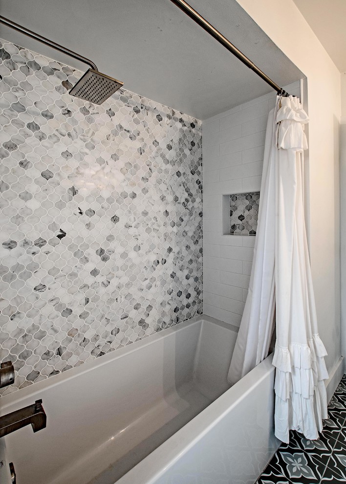 This is an example of a medium sized contemporary shower room bathroom in Orange County with shaker cabinets, white cabinets, an alcove bath, a shower/bath combination, grey tiles, white tiles, marble tiles, white walls, cement flooring, a submerged sink, quartz worktops, multi-coloured floors, a shower curtain and white worktops.