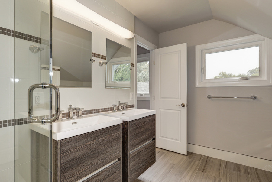 Doorless shower - large transitional master brown tile, white tile and mosaic tile light wood floor doorless shower idea in DC Metro with flat-panel cabinets, distressed cabinets, a two-piece toilet, white walls, an integrated sink and quartz countertops
