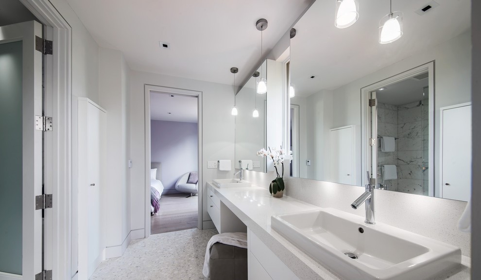 This is an example of a contemporary bathroom in Miami with flat-panel cabinets, white cabinets and granite worktops.