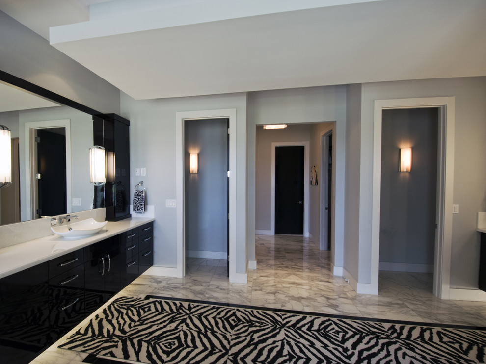 Large contemporary ensuite bathroom in Orlando with freestanding cabinets, dark wood cabinets, a corner bath, a bidet, multi-coloured tiles, stone tiles, grey walls, marble flooring, a vessel sink and marble worktops.