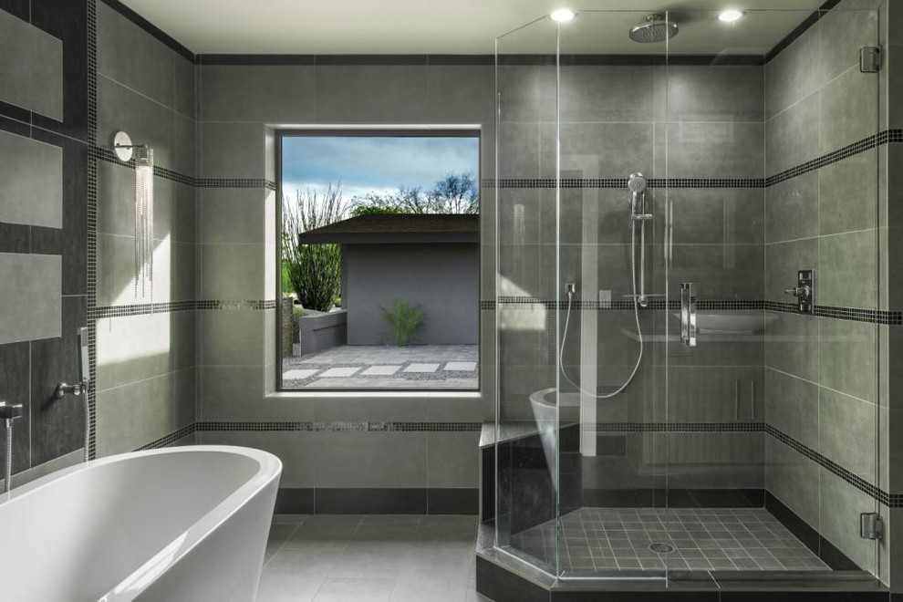 Inspiration for a large contemporary master gray tile and porcelain tile porcelain tile bathroom remodel in Phoenix with a vessel sink, flat-panel cabinets, gray cabinets, marble countertops, a one-piece toilet and gray walls