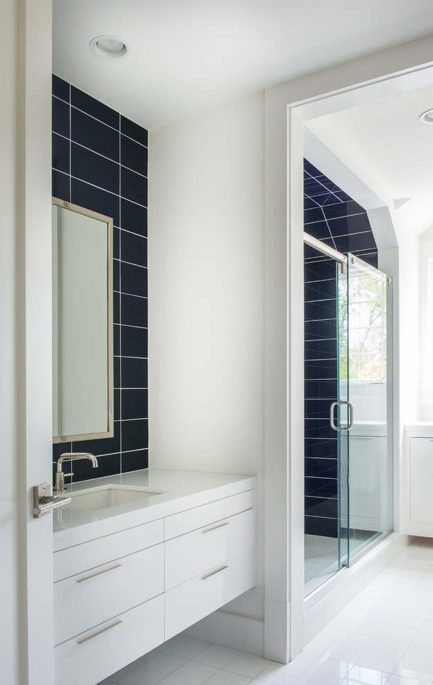 Example of a trendy kids' black tile and ceramic tile bathroom design in New York with flat-panel cabinets, white cabinets and a drop-in sink