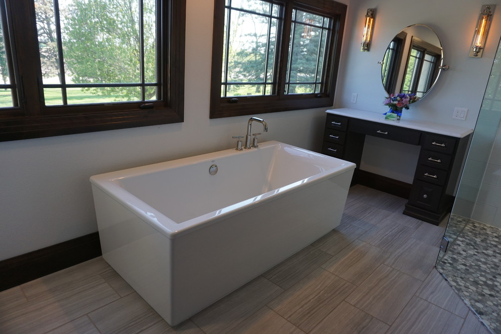 Example of a large trendy master white tile and porcelain tile porcelain tile and gray floor bathroom design in Other with raised-panel cabinets, dark wood cabinets, a two-piece toilet, gray walls, an undermount sink, quartzite countertops and a hinged shower door