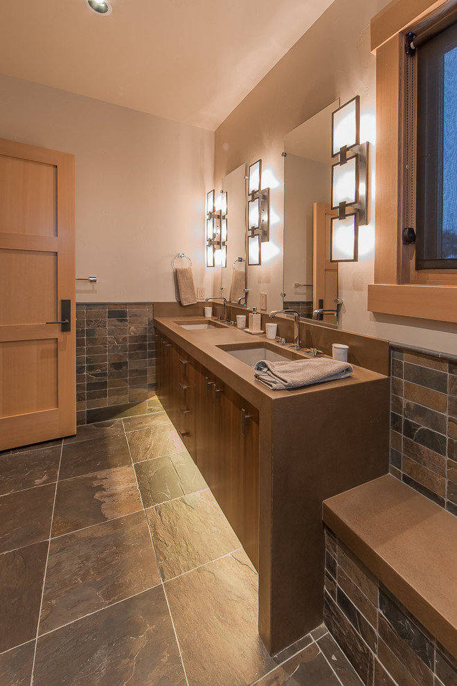 Example of a large trendy master multicolored tile and slate tile slate floor and multicolored floor bathroom design in Denver with flat-panel cabinets, dark wood cabinets, beige walls, an undermount sink and limestone countertops