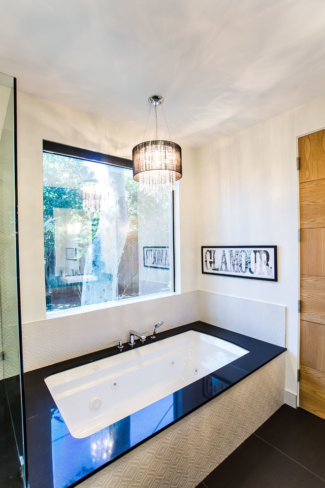 Inspiration for a large contemporary master black and white tile and ceramic tile ceramic tile bathroom remodel in Los Angeles with flat-panel cabinets, a one-piece toilet, black walls and quartz countertops