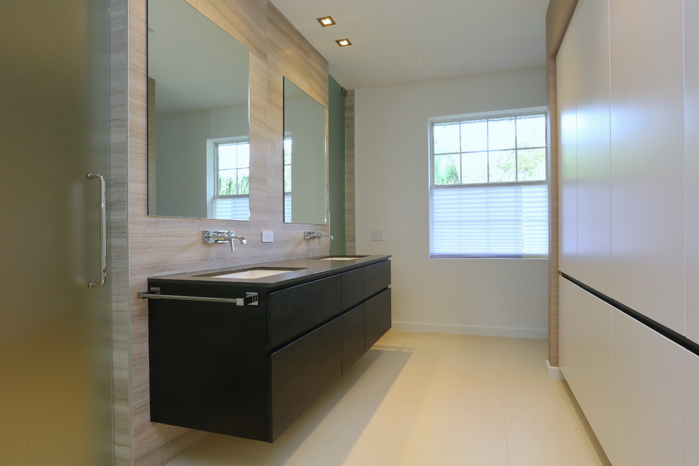 Réalisation d'une salle de bain design avec un lavabo encastré, un placard à porte plane, des portes de placard grises, un plan de toilette en marbre, WC à poser et un carrelage beige.