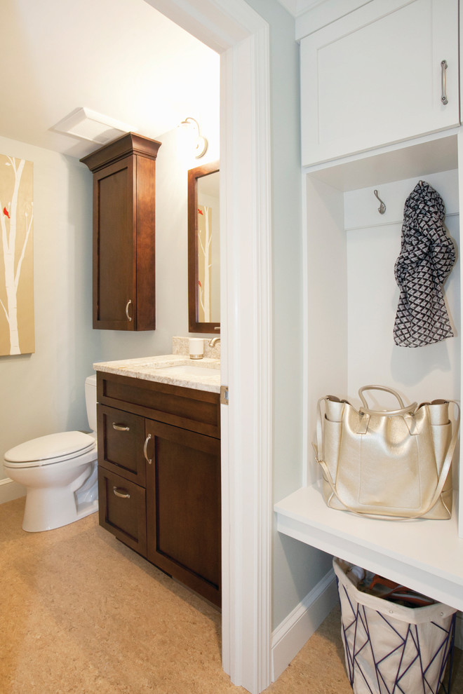 Bild på ett vintage badrum, med ett undermonterad handfat, luckor med infälld panel, skåp i mörkt trä, bänkskiva i kvarts, en toalettstol med hel cisternkåpa, brun kakel, porslinskakel, grå väggar och klinkergolv i porslin