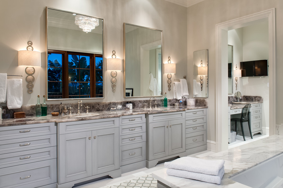 Medium sized classic grey and white ensuite bathroom in Miami with recessed-panel cabinets, grey cabinets, a submerged bath, white tiles, marble tiles, grey walls, ceramic flooring, a submerged sink, marble worktops and beige floors.