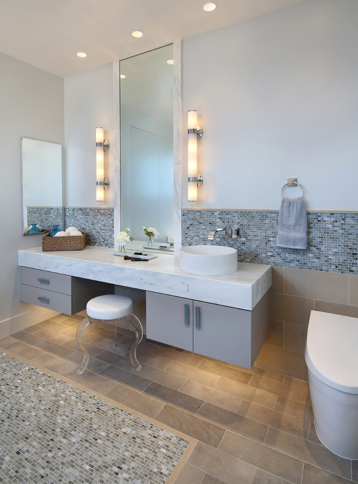 Inspiration for a contemporary bathroom in San Francisco with flat-panel cabinets, grey cabinets, a one-piece toilet, multi-coloured tiles, mosaic tiles, grey walls, mosaic tile flooring and a vessel sink.