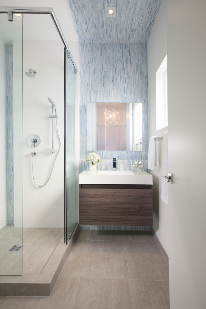 Foto de cuarto de baño contemporáneo con armarios con paneles lisos, puertas de armario de madera en tonos medios, ducha esquinera, aseo y ducha y lavabo integrado