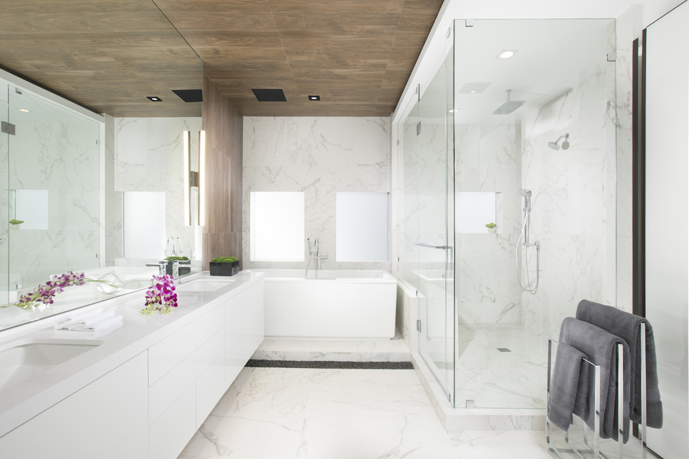 Diseño de cuarto de baño principal contemporáneo con armarios con paneles lisos, puertas de armario blancas, bañera exenta, ducha esquinera y baldosas y/o azulejos blancos