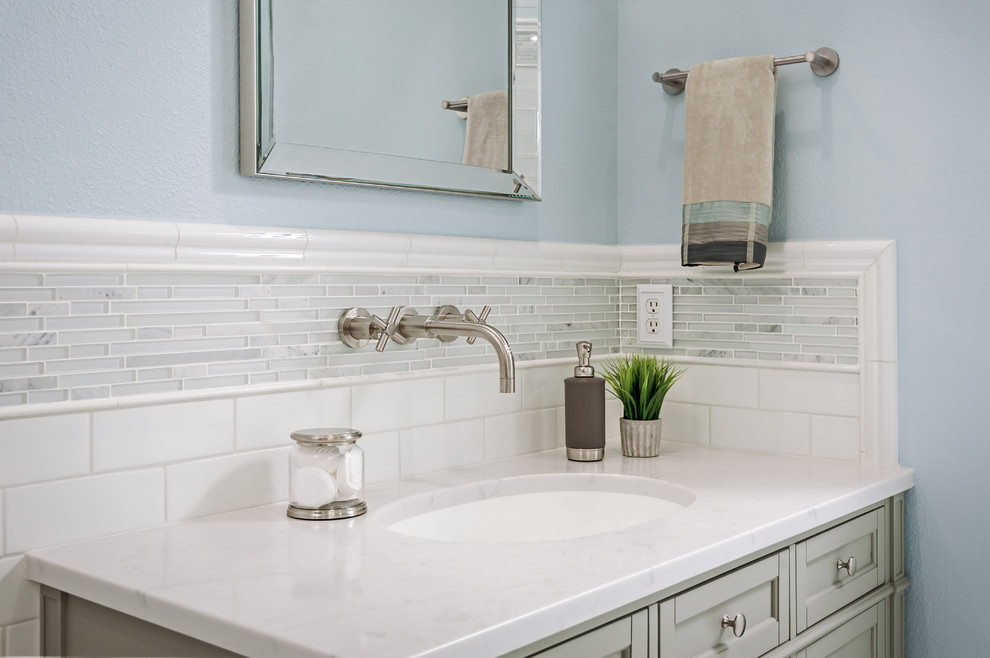 Example of a small trendy 3/4 white tile and subway tile bathroom design in Tampa with recessed-panel cabinets, gray cabinets, blue walls, an undermount sink, quartz countertops and white countertops