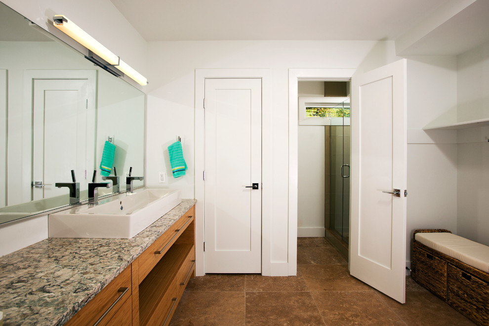 Design ideas for a contemporary ensuite bathroom in DC Metro with a vessel sink, flat-panel cabinets, medium wood cabinets, granite worktops, white walls, travertine flooring, an alcove shower and a two-piece toilet.