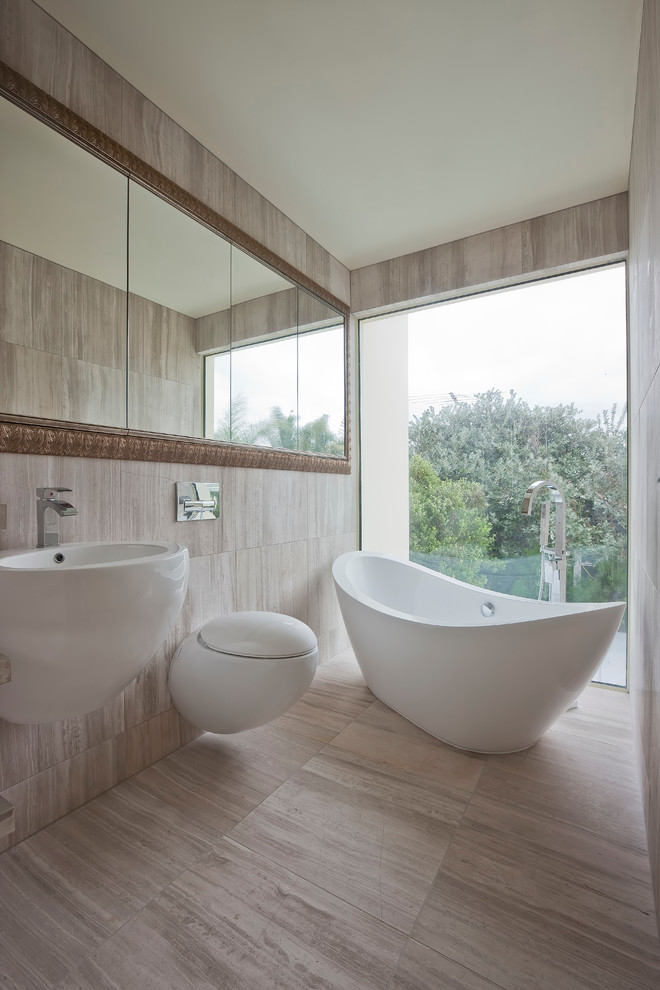 Inspiration for a contemporary freestanding bathtub remodel in Auckland with a wall-mount toilet and a wall-mount sink