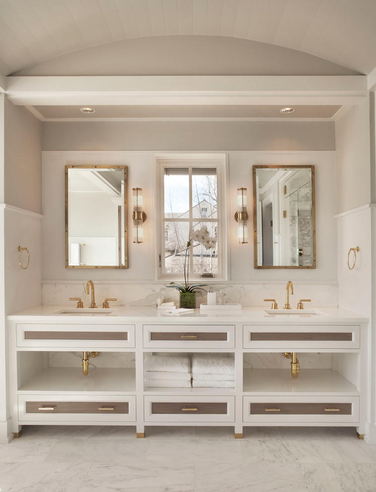 Photo of a coastal grey and white bathroom in New York with marble flooring and recessed-panel cabinets.