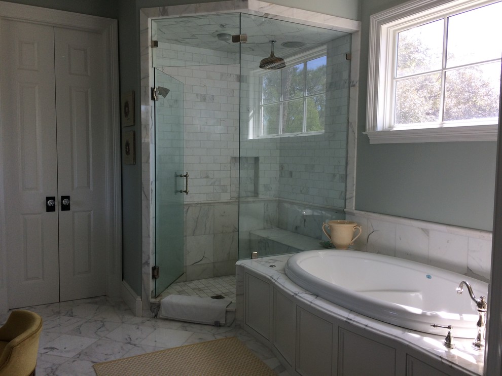 This is an example of a medium sized classic ensuite bathroom in New Orleans with beaded cabinets, white cabinets, a built-in bath, a corner shower, a two-piece toilet, white tiles, green walls, marble flooring, a submerged sink and marble worktops.