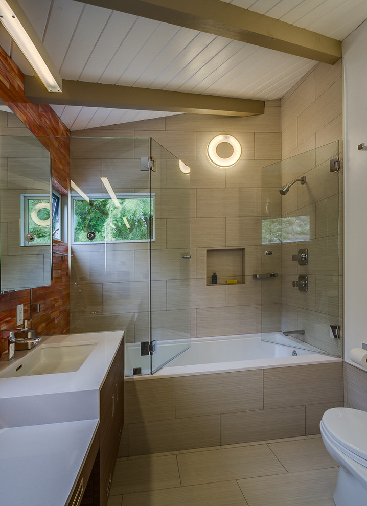 Inspiration for a mid-sized contemporary master multicolored tile and glass tile ceramic tile bathroom remodel in Los Angeles with a trough sink, flat-panel cabinets, dark wood cabinets, solid surface countertops, a one-piece toilet and white walls