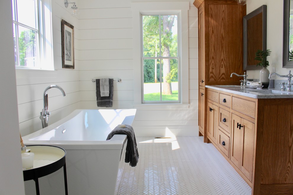 Inspiration for a large farmhouse ensuite bathroom in Boston with recessed-panel cabinets, medium wood cabinets, a freestanding bath, porcelain tiles, white walls, porcelain flooring, a submerged sink, engineered stone worktops, white floors, an open shower and grey worktops.