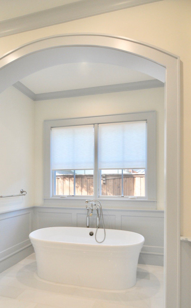 Photo of a large classic ensuite bathroom in Dallas with white cabinets, a freestanding bath, white tiles, white walls, white floors, a hinged door and a built in vanity unit.