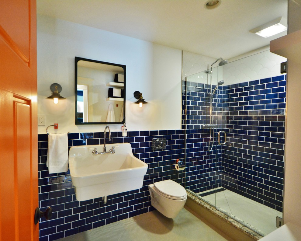 Medium sized coastal bathroom in Boston with a wall-mounted sink, an alcove shower, a wall mounted toilet, blue tiles, ceramic tiles, blue walls and porcelain flooring.
