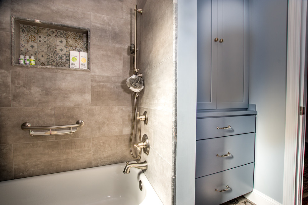 Cette image montre une petite salle de bain traditionnelle en bois brun avec un placard à porte shaker, une baignoire en alcôve, un combiné douche/baignoire, WC séparés, un carrelage multicolore, des carreaux de céramique, un mur bleu, un sol en carrelage de céramique, un lavabo encastré, un plan de toilette en quartz modifié, un sol multicolore, une cabine de douche avec un rideau et un plan de toilette gris.