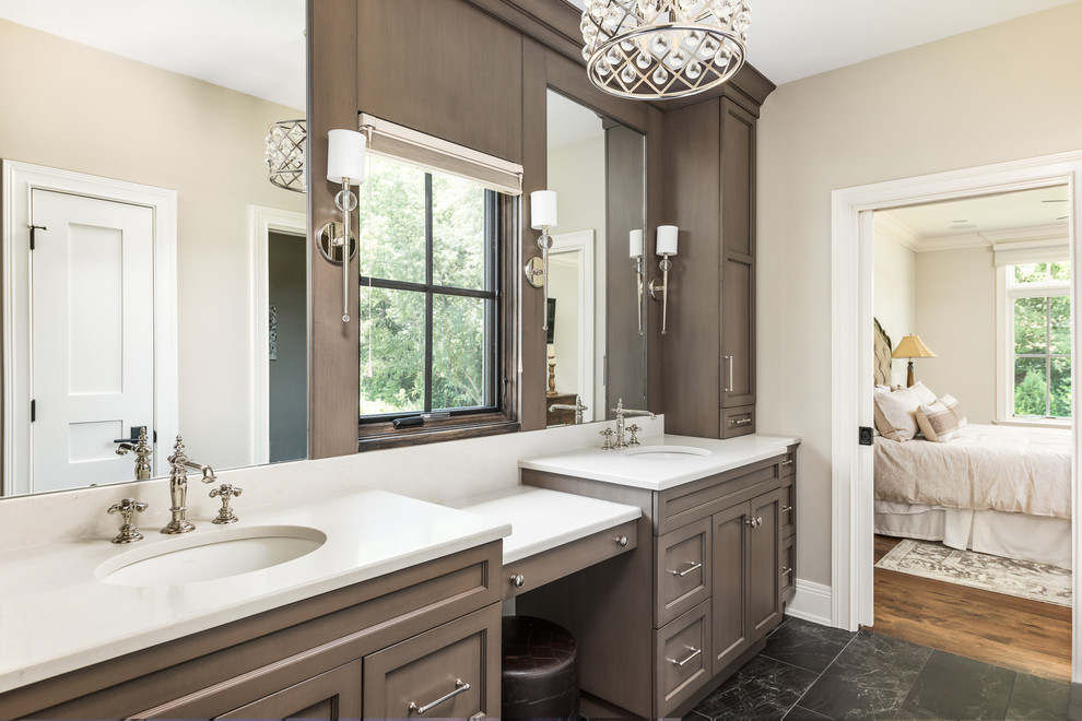 Inspiration for a large traditional ensuite bathroom in Chicago with recessed-panel cabinets, brown cabinets, grey walls, marble flooring, a submerged sink, engineered stone worktops, black floors and white worktops.