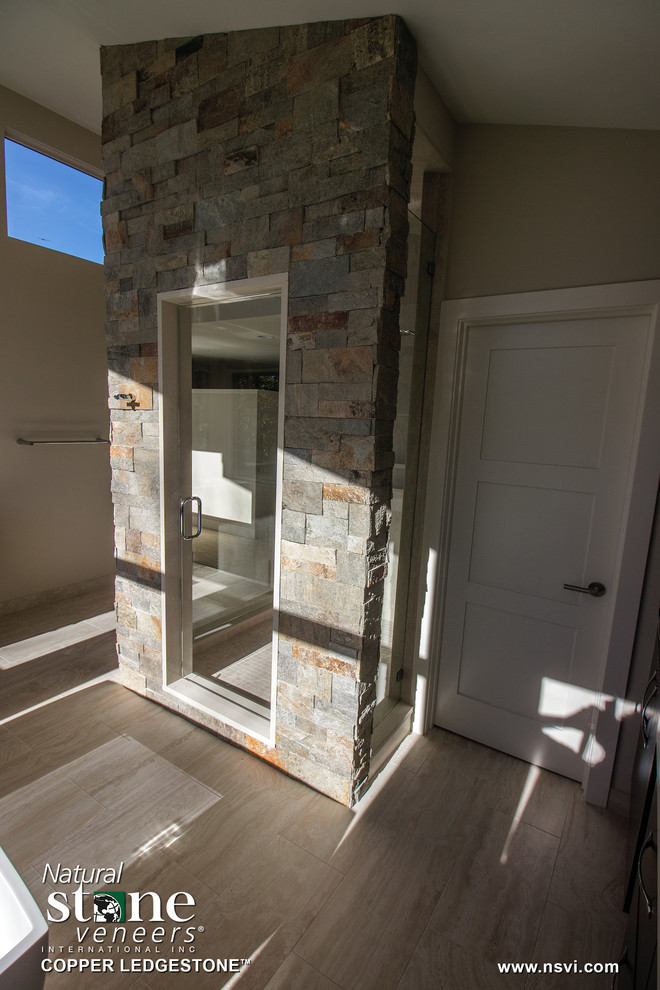 Modern inredning av ett en-suite badrum, med flerfärgad kakel, stenkakel och dusch med gångjärnsdörr