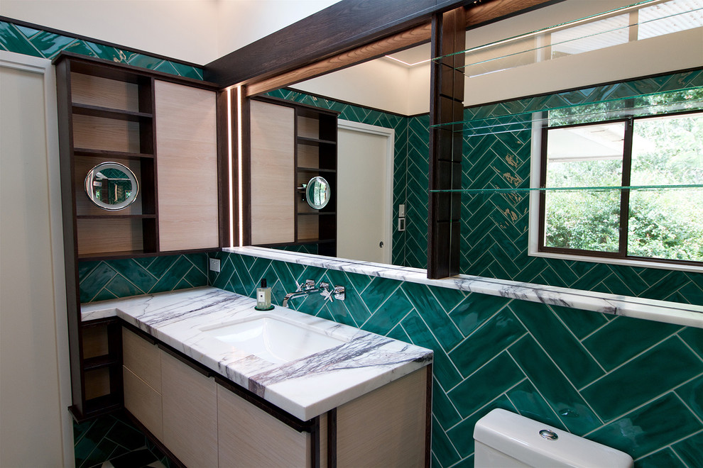 Large contemporary ensuite bathroom in Brisbane with freestanding cabinets, light wood cabinets, a walk-in shower, green tiles, ceramic tiles, white walls, ceramic flooring, a submerged sink, black floors and an open shower.