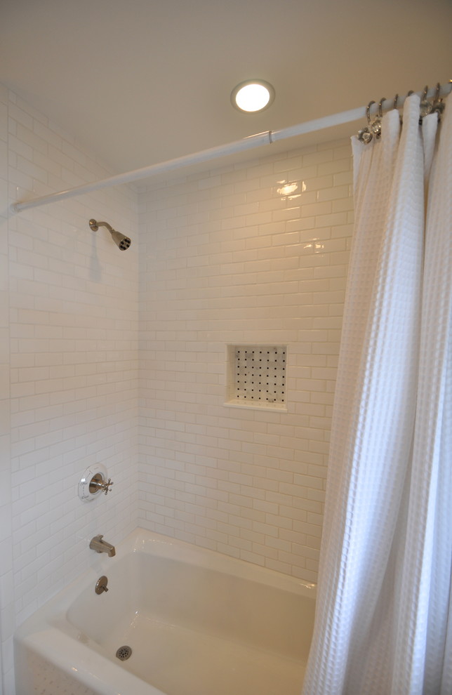 Example of a mid-sized classic kids' white tile and subway tile marble floor alcove bathtub design in New York with shaker cabinets, white cabinets, marble countertops, a two-piece toilet and blue walls