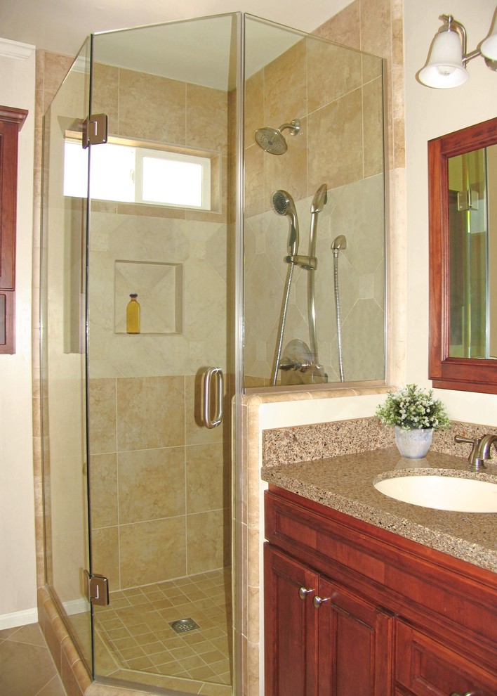 Example of a small classic beige tile and porcelain tile porcelain tile corner shower design in Los Angeles with an undermount sink, recessed-panel cabinets, medium tone wood cabinets, quartz countertops and beige walls