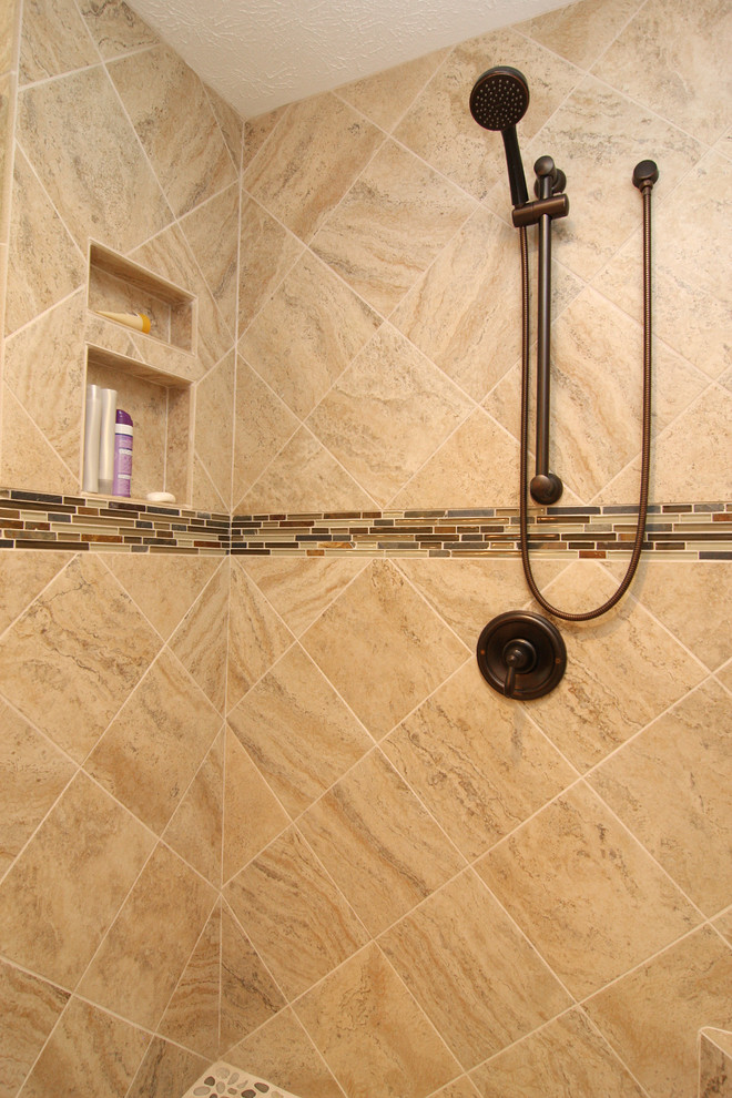 Example of a mid-sized classic master beige tile and ceramic tile ceramic tile corner shower design in Other with an undermount sink, light wood cabinets, granite countertops and beige walls