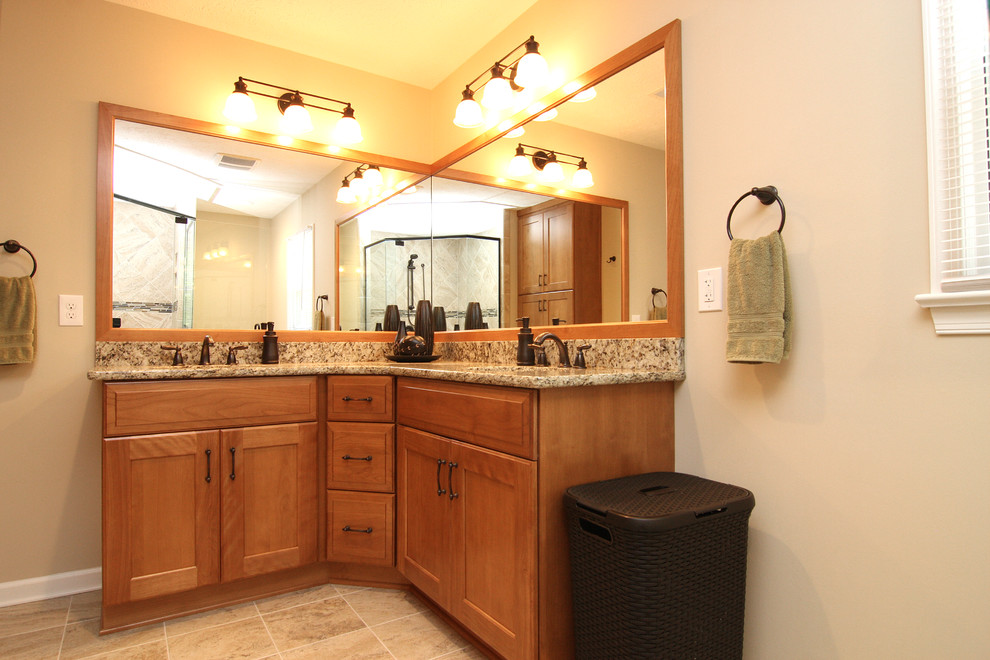 Photo of a medium sized traditional ensuite bathroom in Other with a submerged sink, light wood cabinets, granite worktops, a corner shower, beige tiles, ceramic tiles, beige walls and ceramic flooring.