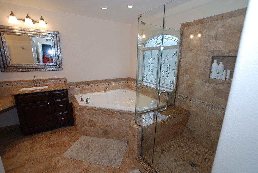 Huge elegant master brown tile and porcelain tile porcelain tile bathroom photo in Orange County with an undermount sink, raised-panel cabinets, dark wood cabinets, granite countertops, a two-piece toilet and white walls