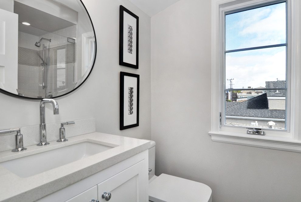 Diseño de cuarto de baño contemporáneo pequeño con armarios estilo shaker, puertas de armario blancas, sanitario de una pieza, paredes grises, aseo y ducha, lavabo bajoencimera y encimera de cuarcita