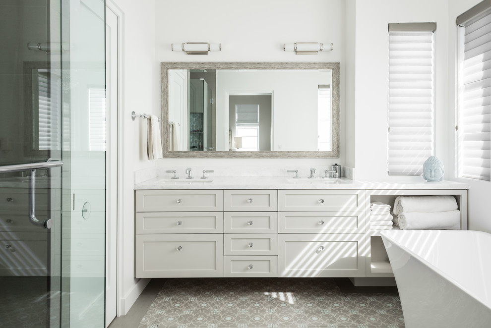 Design ideas for a large contemporary ensuite bathroom in Orange County with shaker cabinets, white cabinets, a freestanding bath, an alcove shower, white walls, porcelain flooring, a submerged sink, marble worktops, multi-coloured floors, a hinged door and white worktops.
