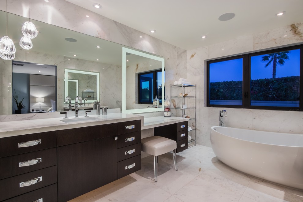 Large trendy master white tile and stone slab marble floor and gray floor bathroom photo in Orange County with an undermount sink, flat-panel cabinets, dark wood cabinets, marble countertops, a one-piece toilet, beige walls and gray countertops