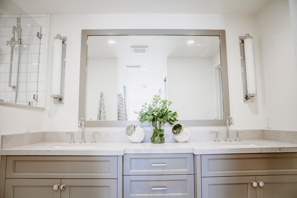 Inspiration for a mid-sized coastal master white tile and ceramic tile ceramic tile and gray floor alcove shower remodel in San Diego with shaker cabinets, gray cabinets, a one-piece toilet, white walls, an undermount sink, quartz countertops and a hinged shower door