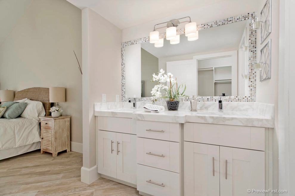 Bild på ett stort funkis en-suite badrum, med ett undermonterad handfat, skåp i shakerstil, vita skåp, marmorbänkskiva, klinkergolv i porslin, en dusch i en alkov, en toalettstol med hel cisternkåpa, vit kakel, porslinskakel och beige väggar