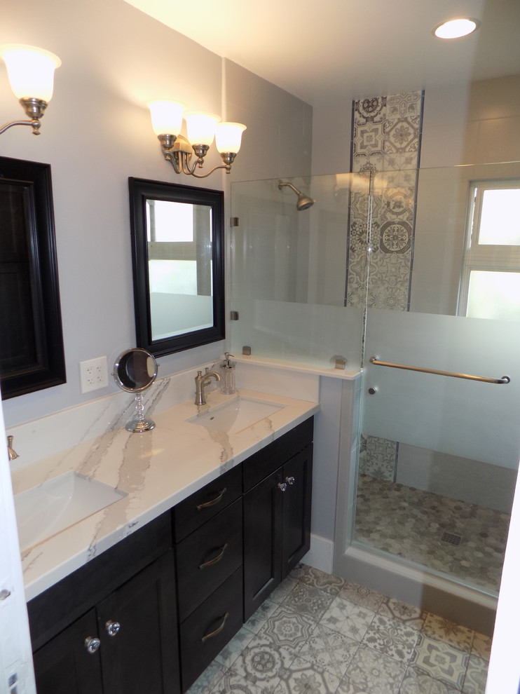 Design ideas for a romantic bathroom in San Diego with shaker cabinets, black cabinets, a walk-in shower, a one-piece toilet, grey tiles, porcelain tiles, grey walls, porcelain flooring, a submerged sink, engineered stone worktops, grey floors and a hinged door.