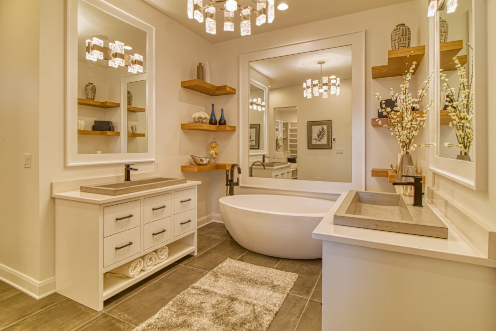 Inspiration for a transitional gray floor and single-sink freestanding bathtub remodel in Boise with flat-panel cabinets, white cabinets, beige walls, a drop-in sink, white countertops and a freestanding vanity