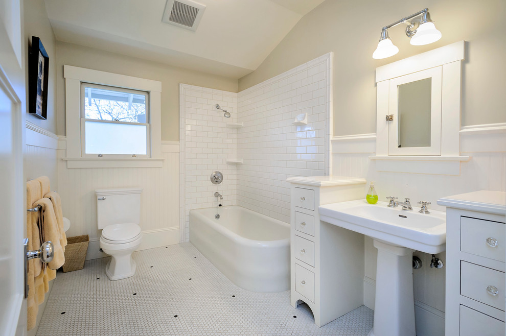Example of an arts and crafts corner bathtub design in San Francisco with a pedestal sink