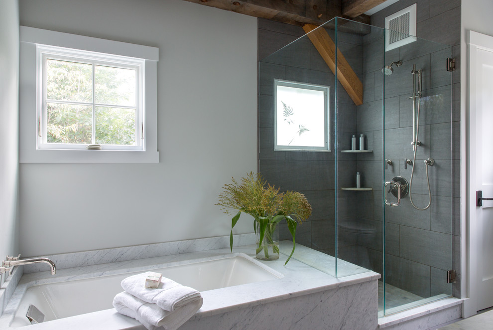 Example of a large classic master gray tile and porcelain tile corner shower design in Portland Maine with furniture-like cabinets, medium tone wood cabinets, an undermount tub, white walls, an undermount sink and marble countertops