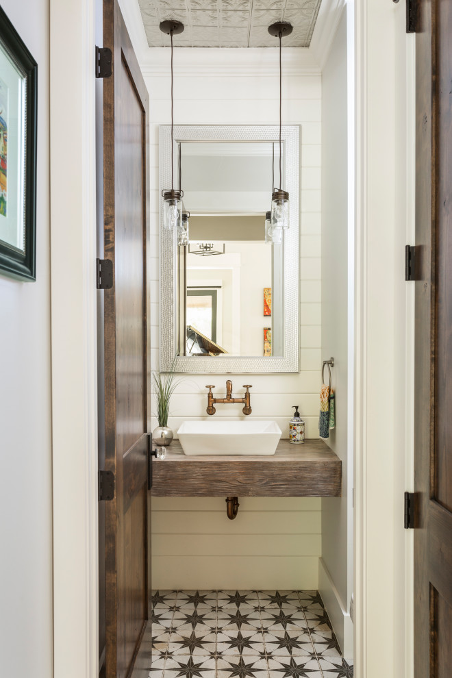 Inspiration for a country bathroom remodel in Denver with open cabinets, brown cabinets and wood countertops