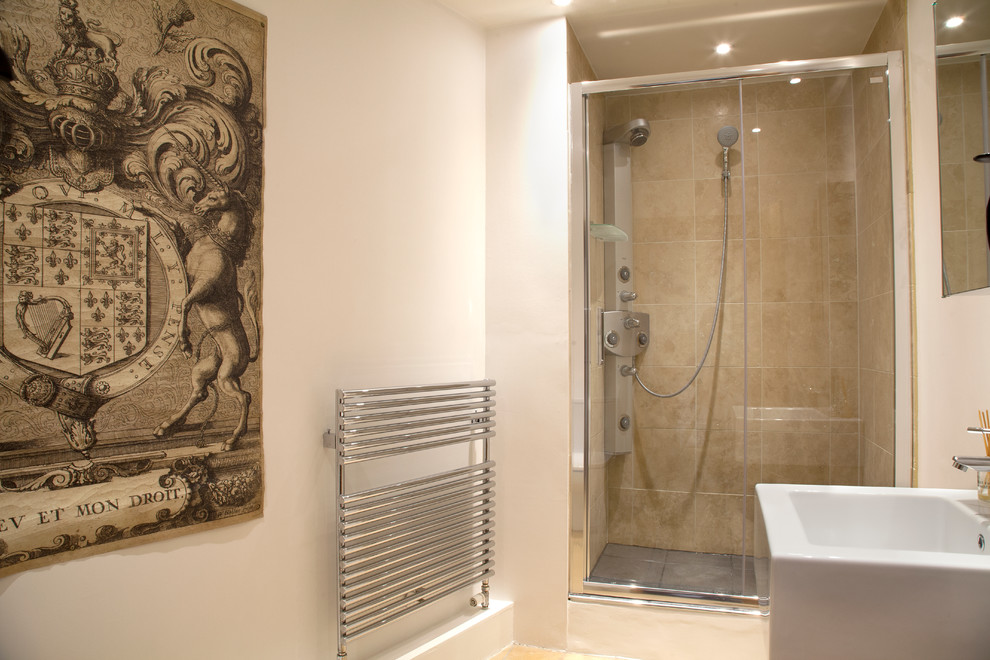 Example of a small eclectic master beige tile and porcelain tile limestone floor walk-in shower design in Gloucestershire with white walls and a wall-mount sink