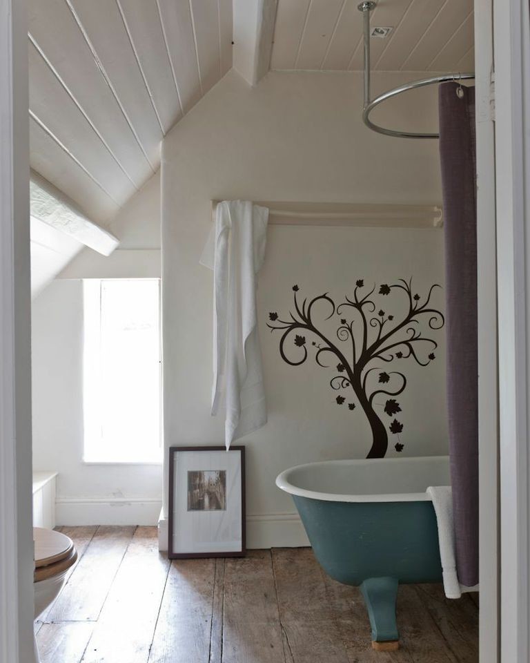 Inspiration for a mid-sized cottage dark wood floor freestanding bathtub remodel in London with white walls
