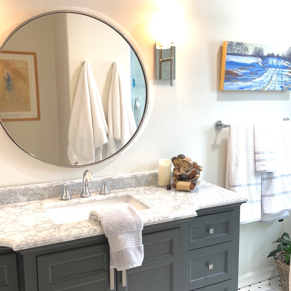 Design ideas for a medium sized classic bathroom in Vancouver with shaker cabinets, grey cabinets, an alcove shower, a one-piece toilet, white tiles, ceramic tiles, beige walls, ceramic flooring, a submerged sink, marble worktops, white floors, a sliding door and grey worktops.