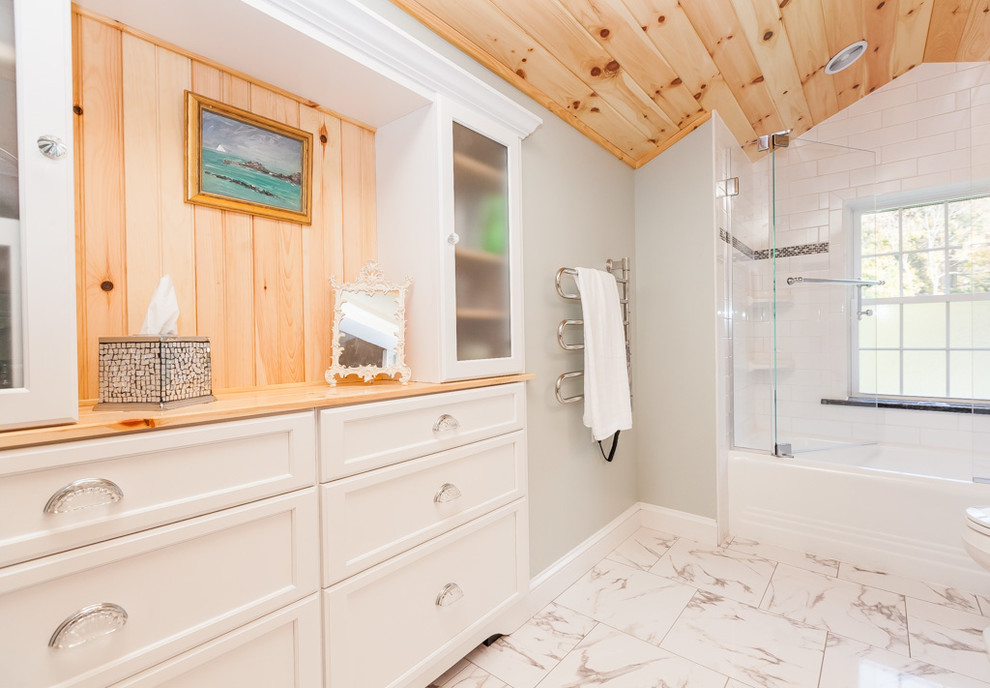 Example of a mid-sized classic master white tile and porcelain tile bathroom design in Boston with recessed-panel cabinets, white cabinets, a two-piece toilet, an undermount sink, granite countertops, gray walls and a hinged shower door